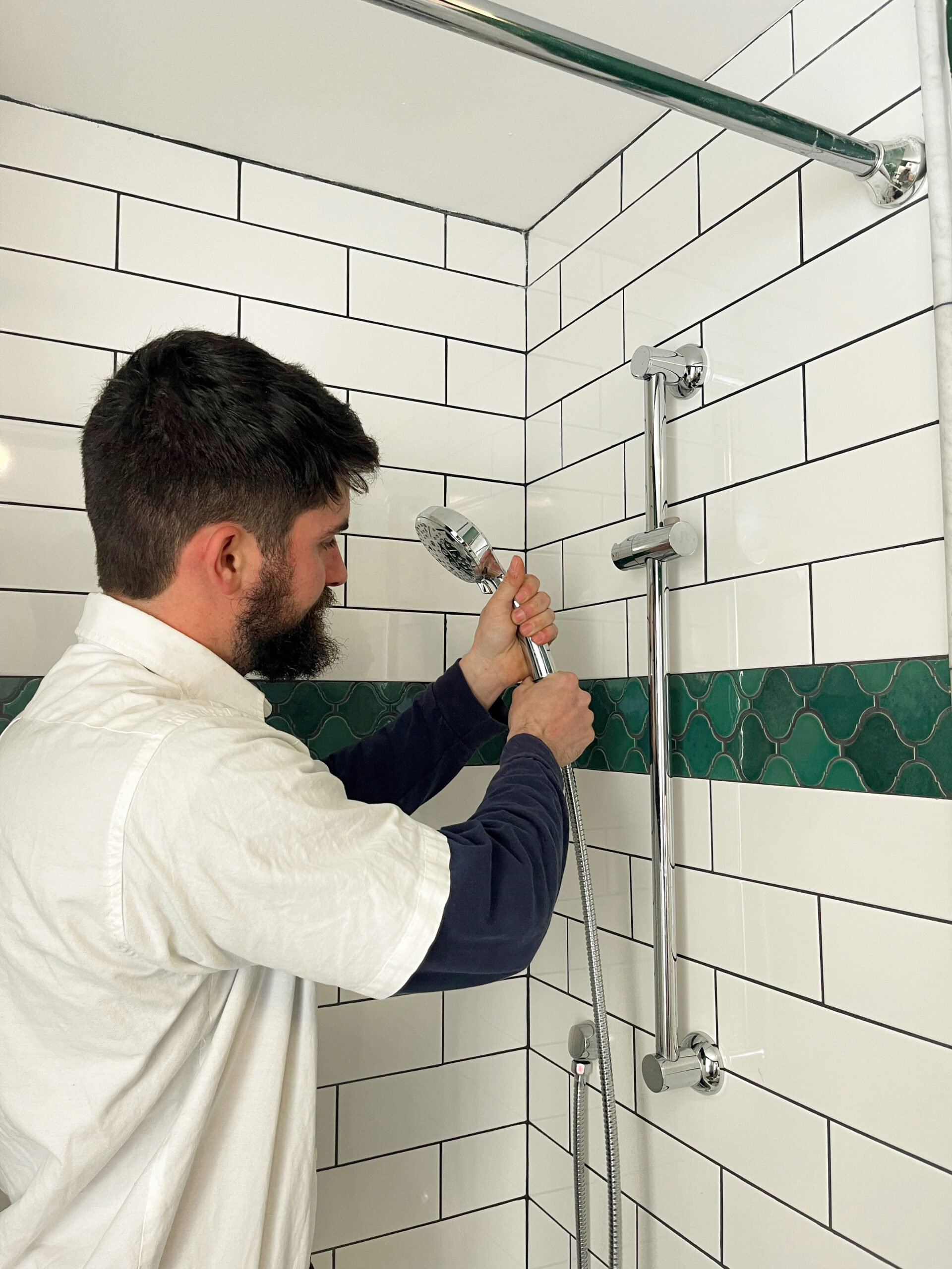 Image of a Paramount Plumbing HVAC Employee working on a shower