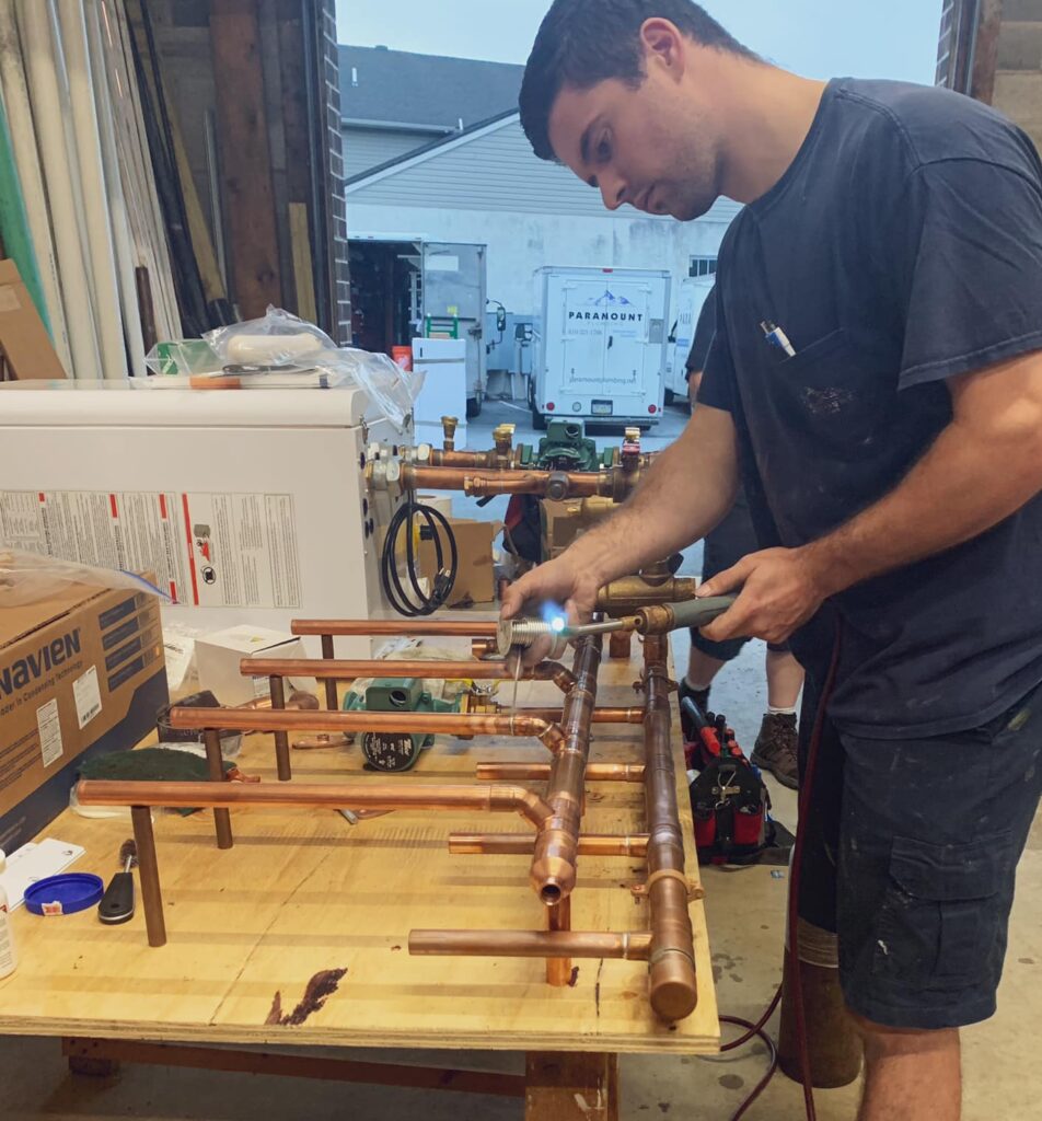 Image of an employee repairing a boiler